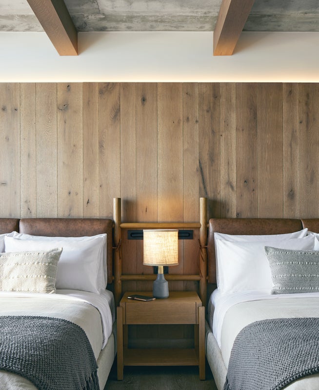 Two double beds with wooden headboards sit side by side