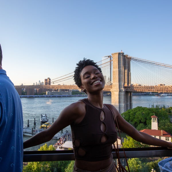 Person smiling with the Brooklyn Bridge in the background