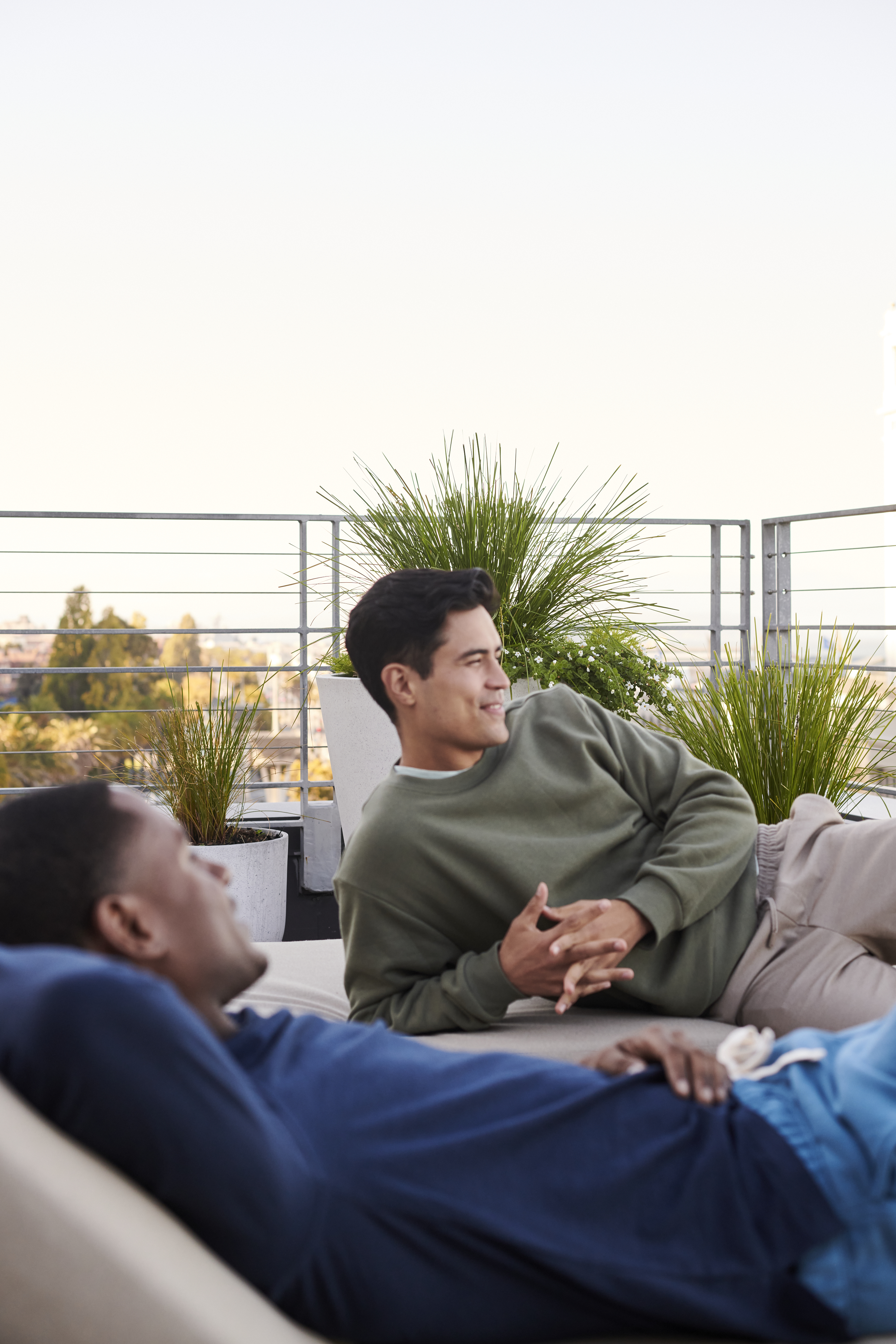 Two men lounging outside on their patio