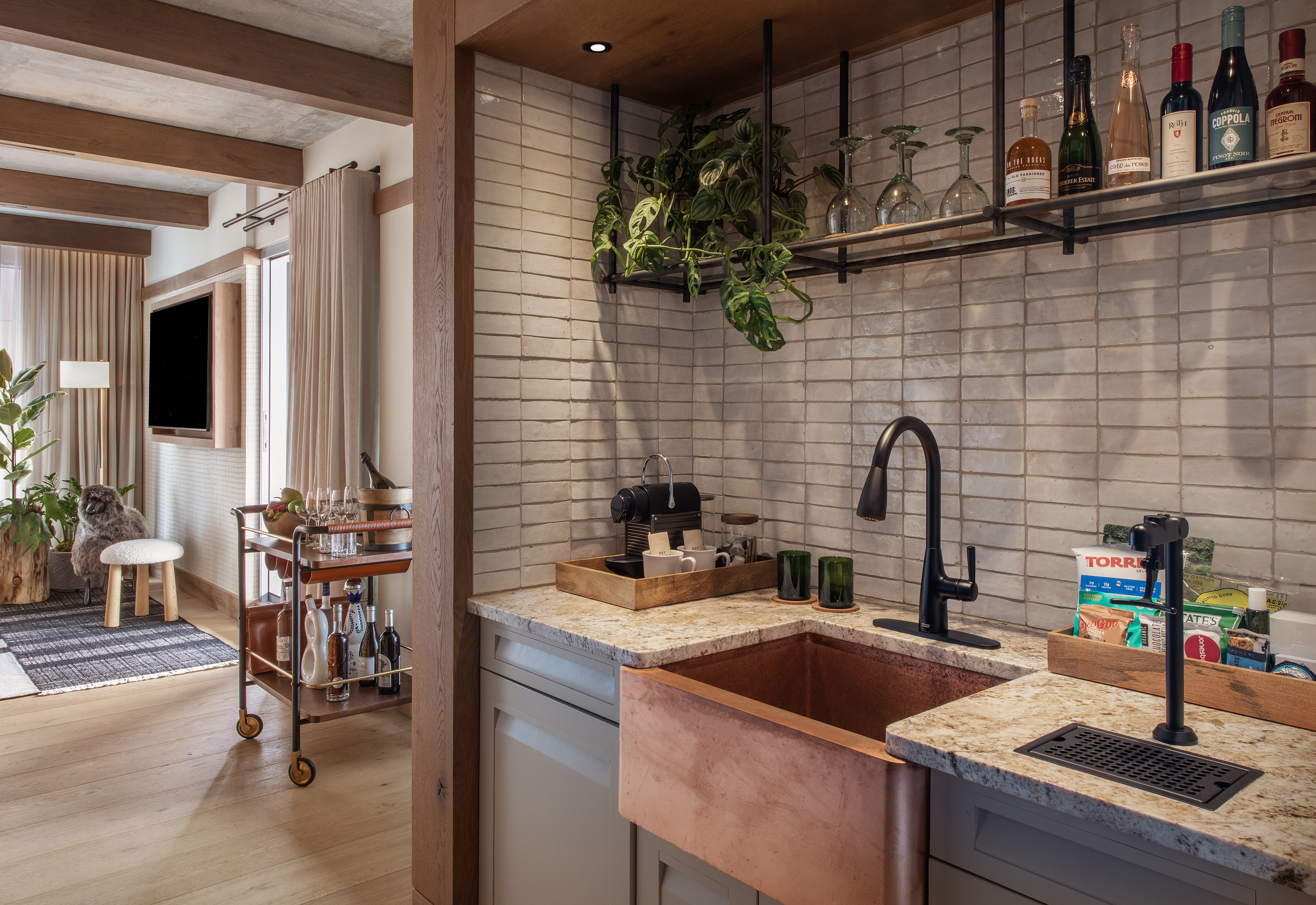 Kitchen with a grey slate back splash and copper sink