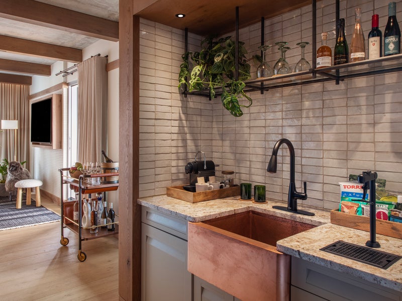 Kitchen with a grey slate back splash and copper sink