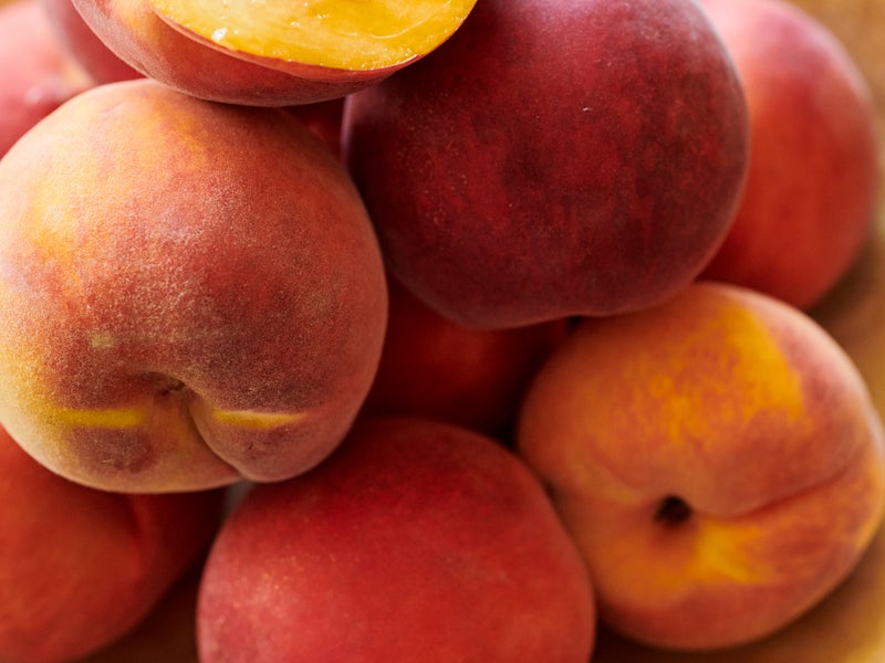 Peaches on a wooden plate