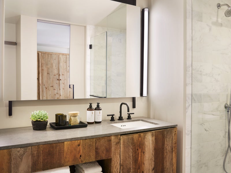 Ivory tiled bathroom with wooden vanity