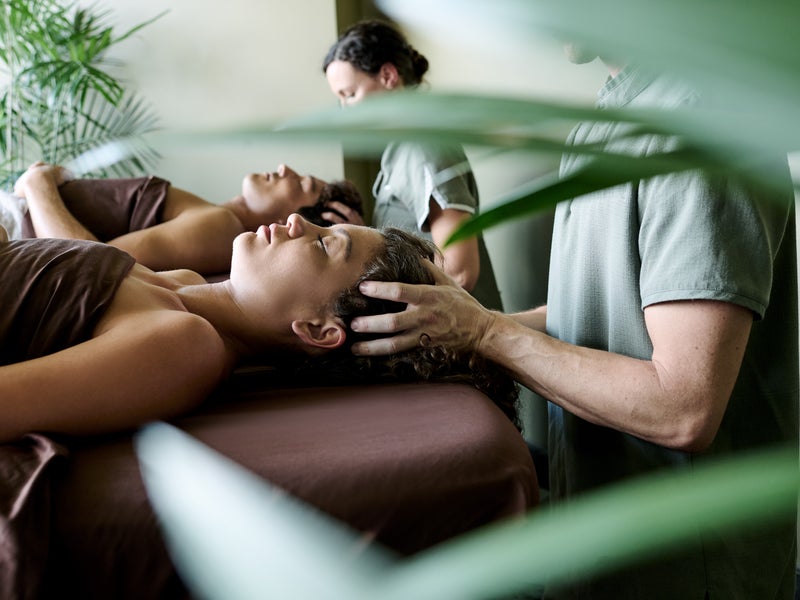 Two people enjoying a scalp massage