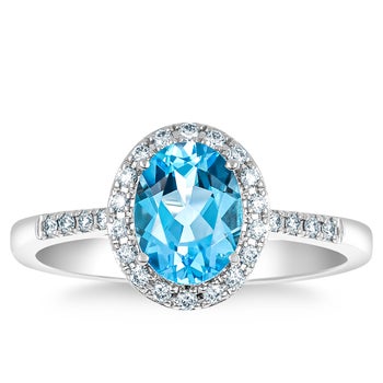 Oval Cut Blue Topaz and Diamond Ring in White Gold (0.15 ctw)