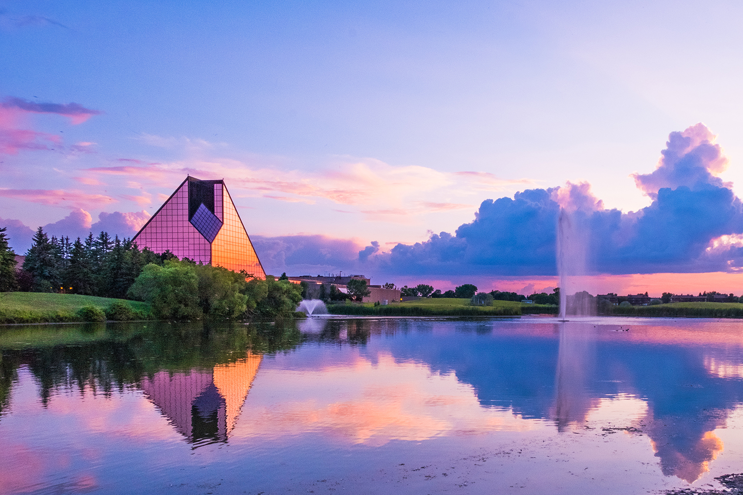 Sunset reflecting off a lake and the Royal Canadian Mint in Winnipeg, Manitoba