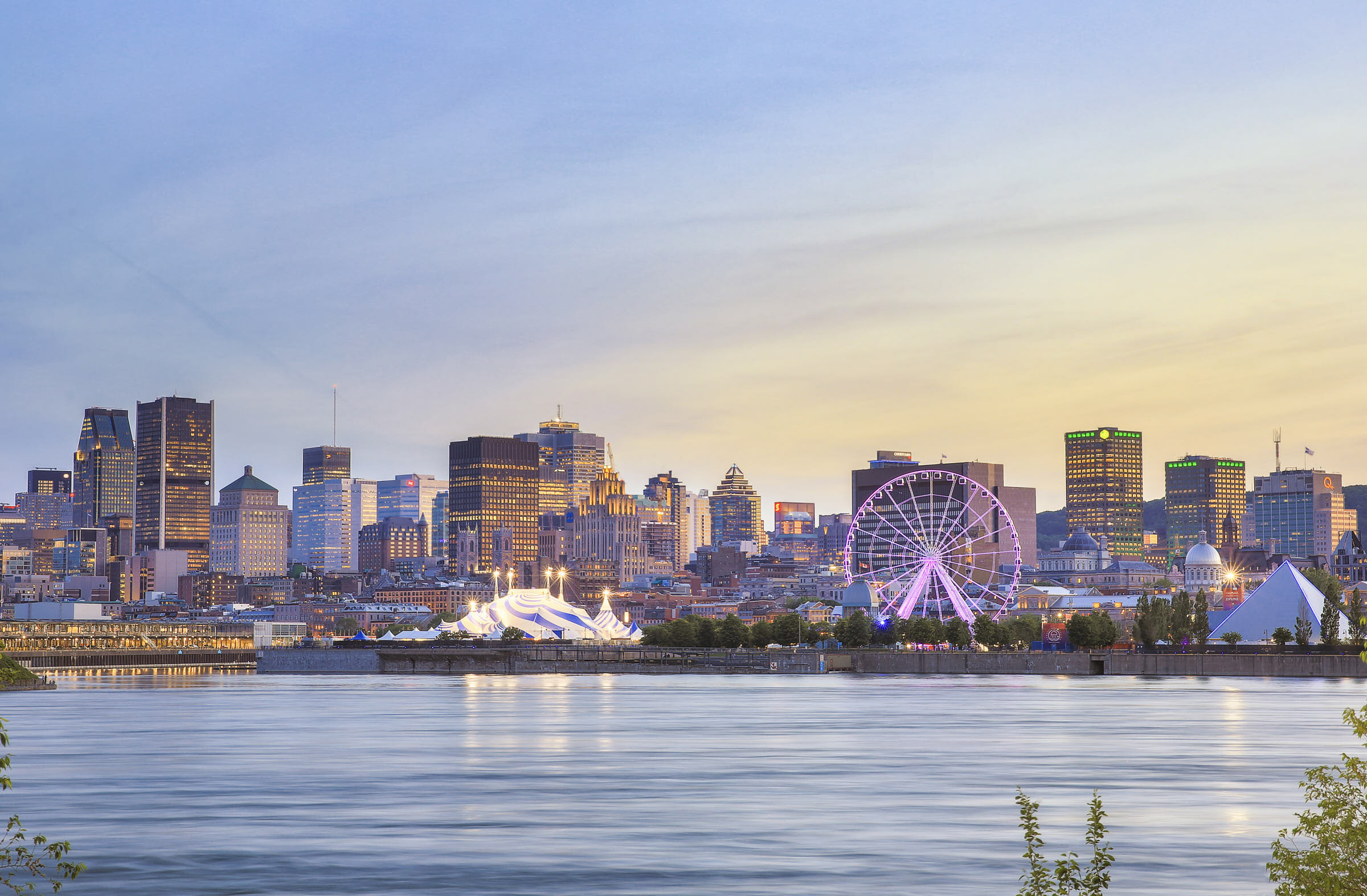 Montreal city skyline just before sunset with the St. Lawrence River in front