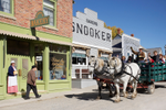 Horse and wagon take visitors past heritage buildings in Calgary’s Heritage Park Historical Village