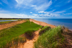 View of blue sky above red sand dunes on Prince Edward Island