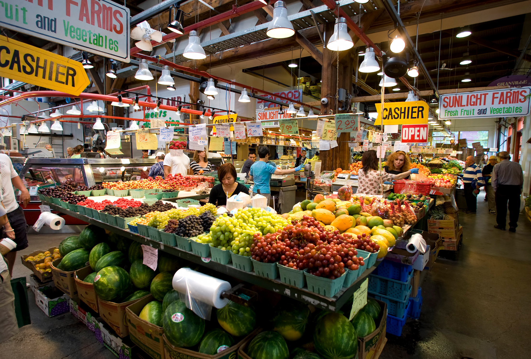 Interior of Granville Island Public Market with people shopping