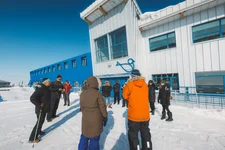 People in winter jackets standing outside the Churchill Northern Studies Centre