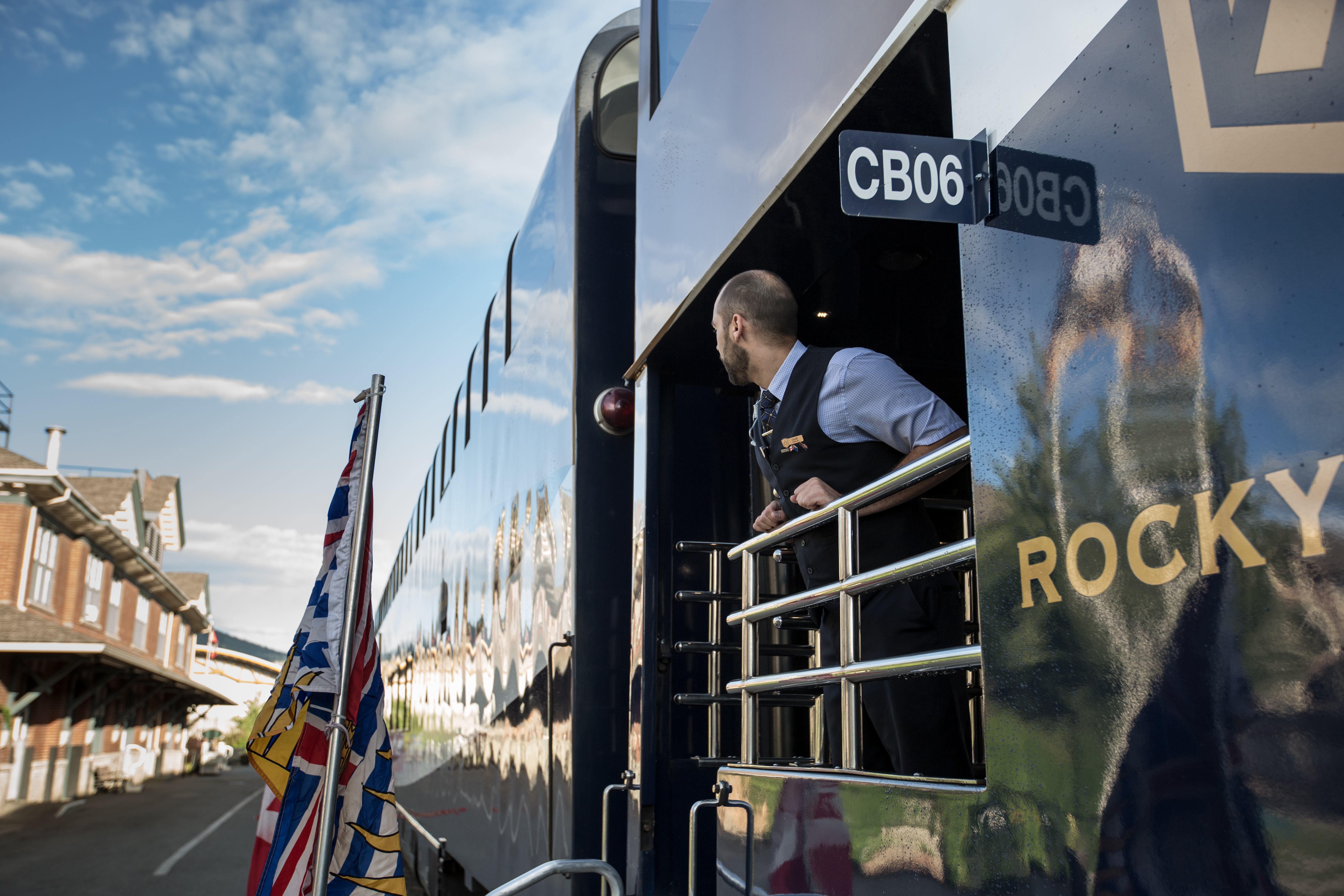 A Rocky Mountaineer train's outdoor viewing platform at the Banff Station
