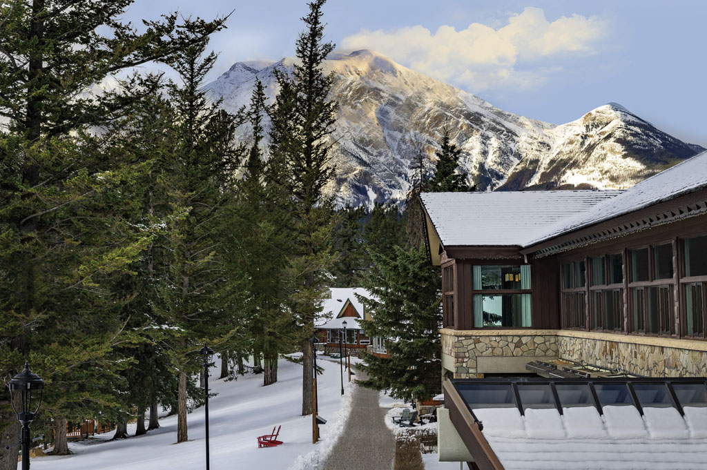Exterior of Jasper Park Lodge with snowy mountains in the distance