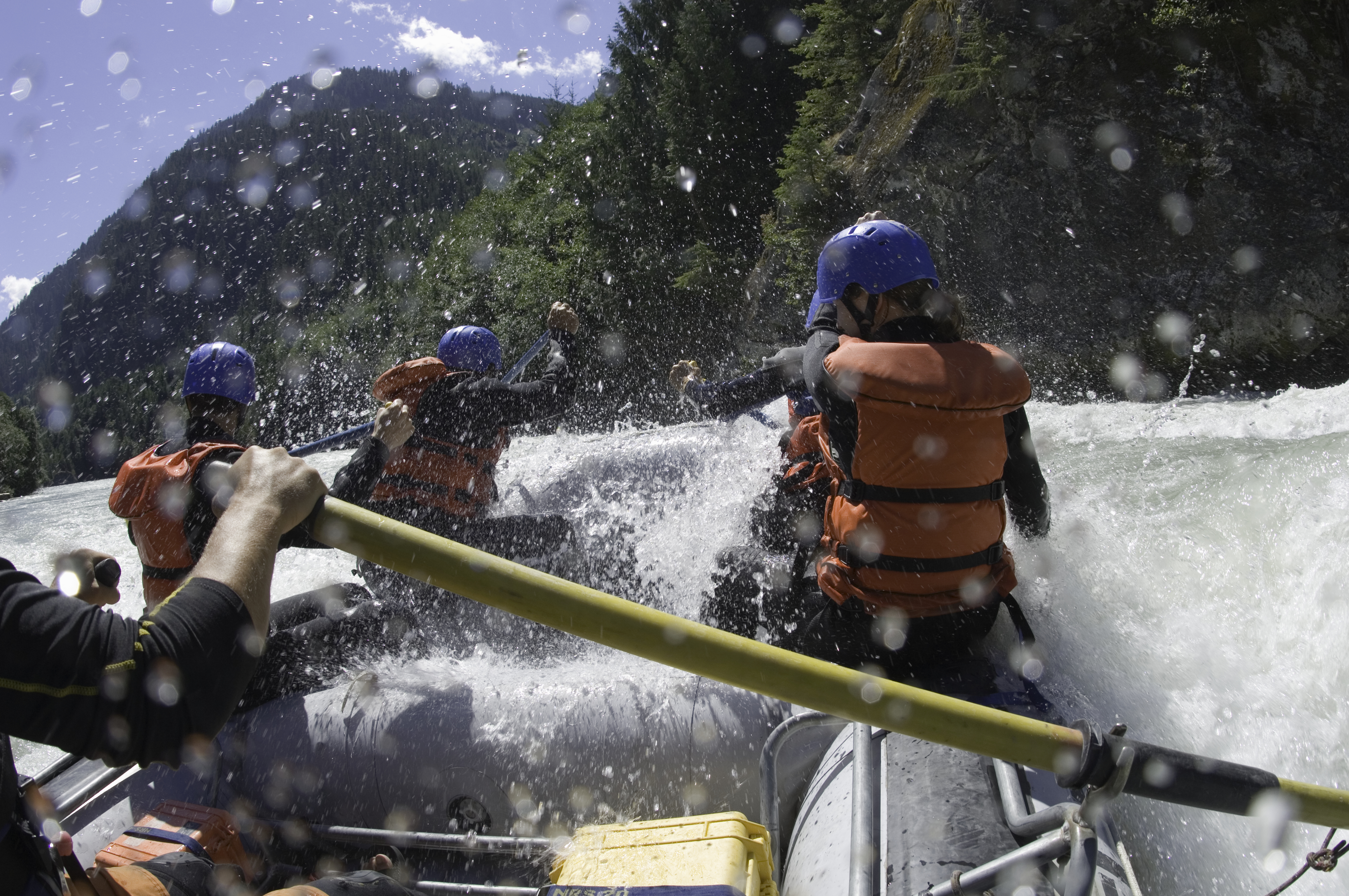 Close up rear view of people whitewater rafting down a river in Squamish