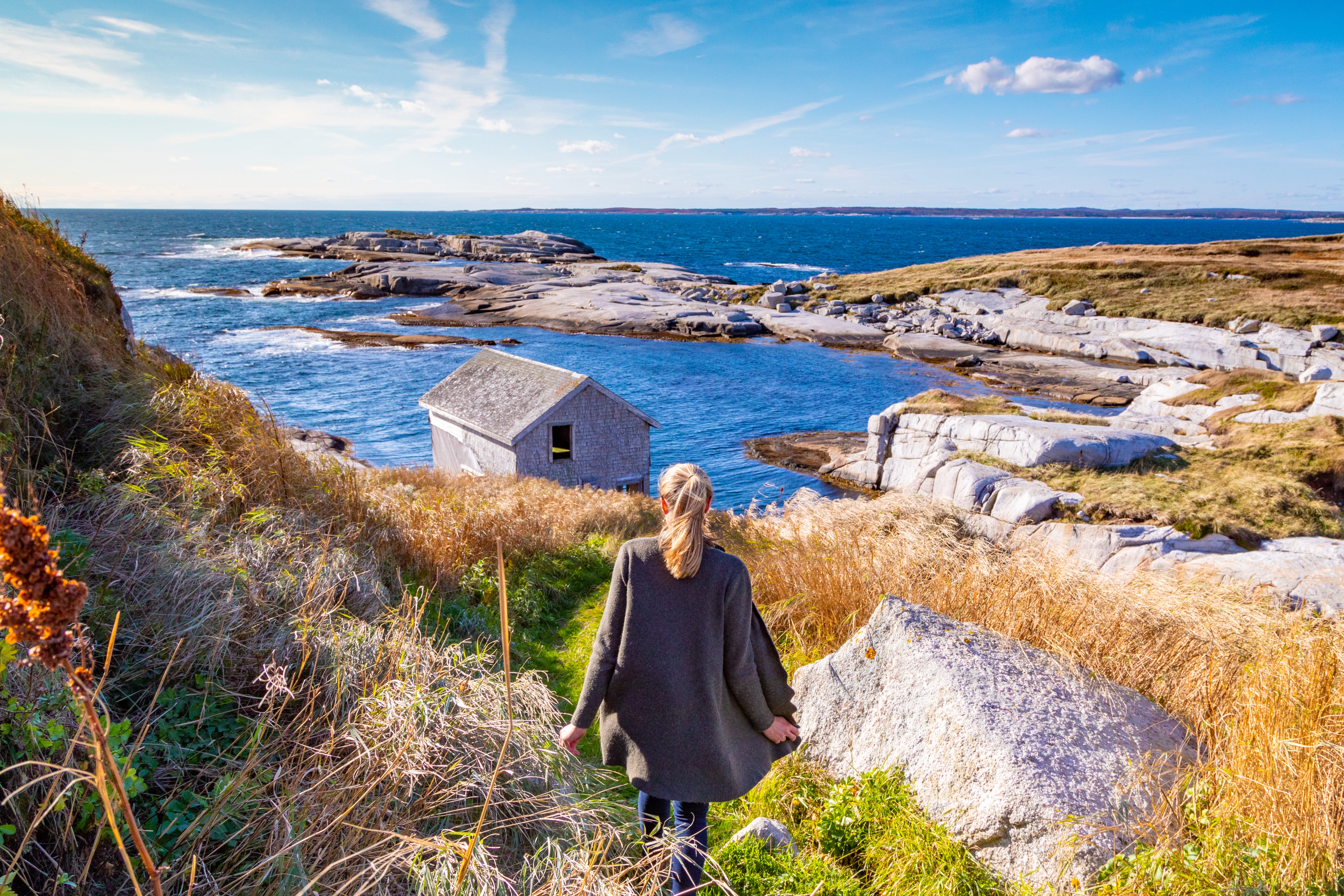 Woman looking out at the rugged coastline near Halifax