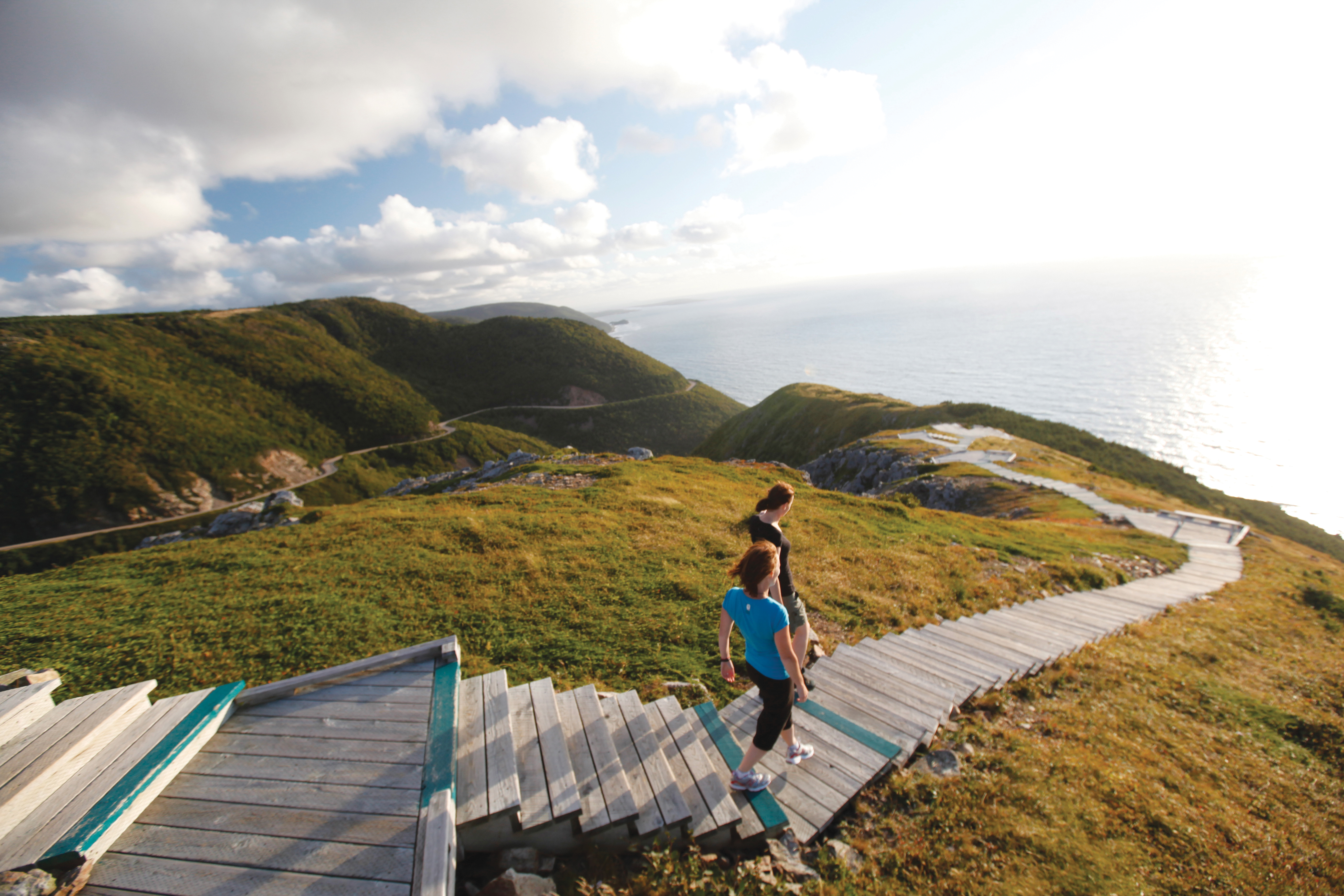Two women walking down steps on coastline trail, Cape Breton Island