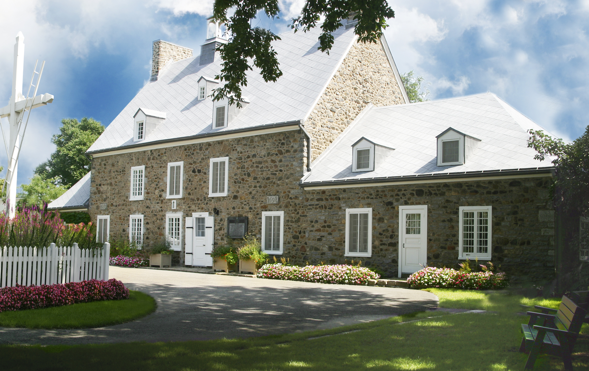An old farmhouse with white doors and roof