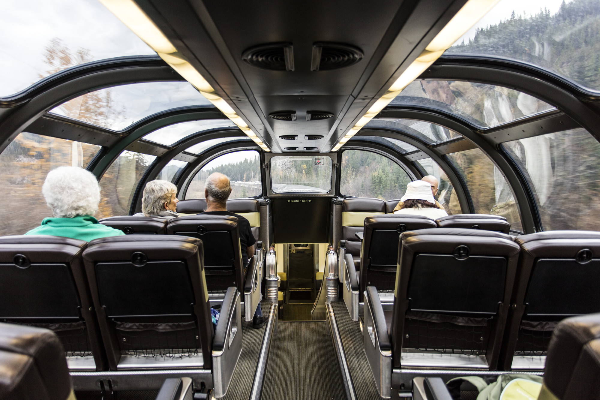 Passengers seated inside one of VIA Rail's dome cars