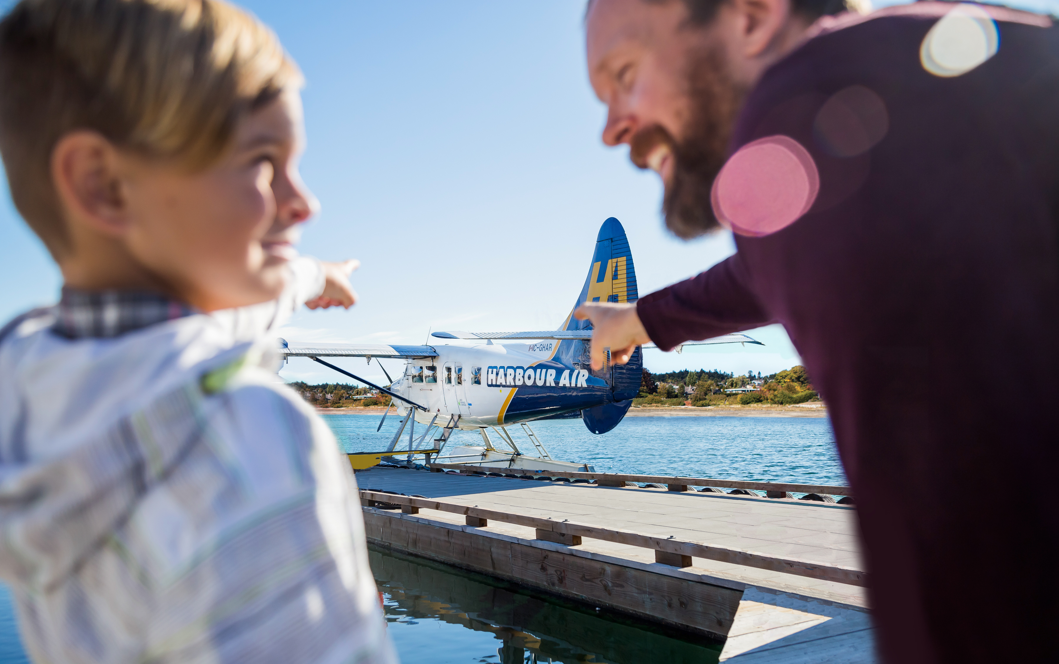 dad and child point at seaplane