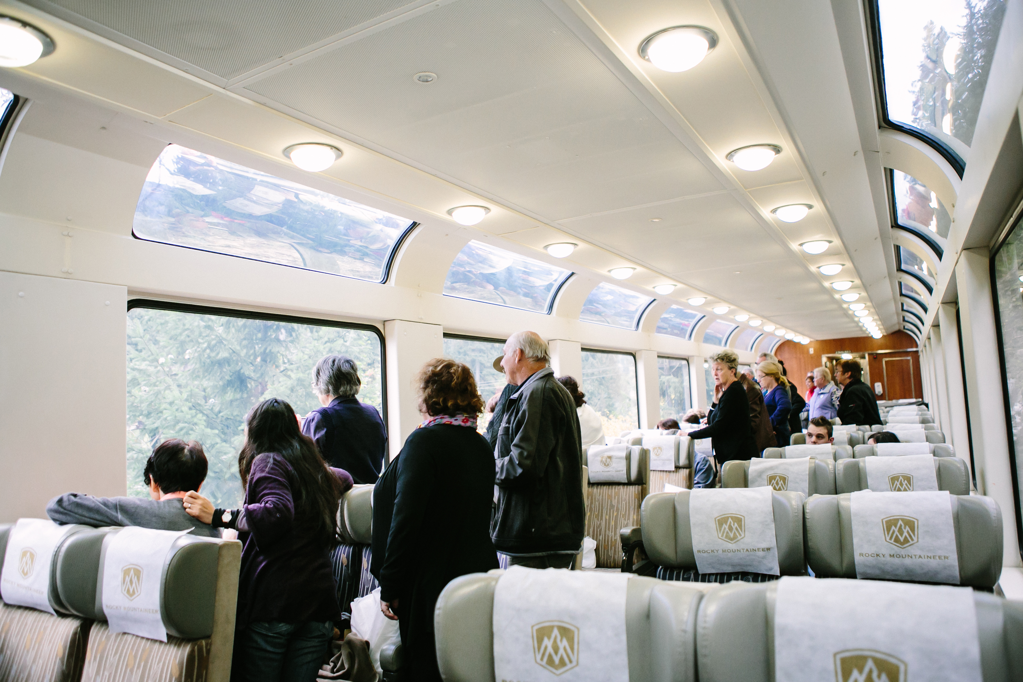 Rocky Mountaineer guests enjoying the view from the SilverLeaf coach