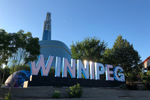 Close up of a large outdoor Winnipeg sign on the top of some steps 