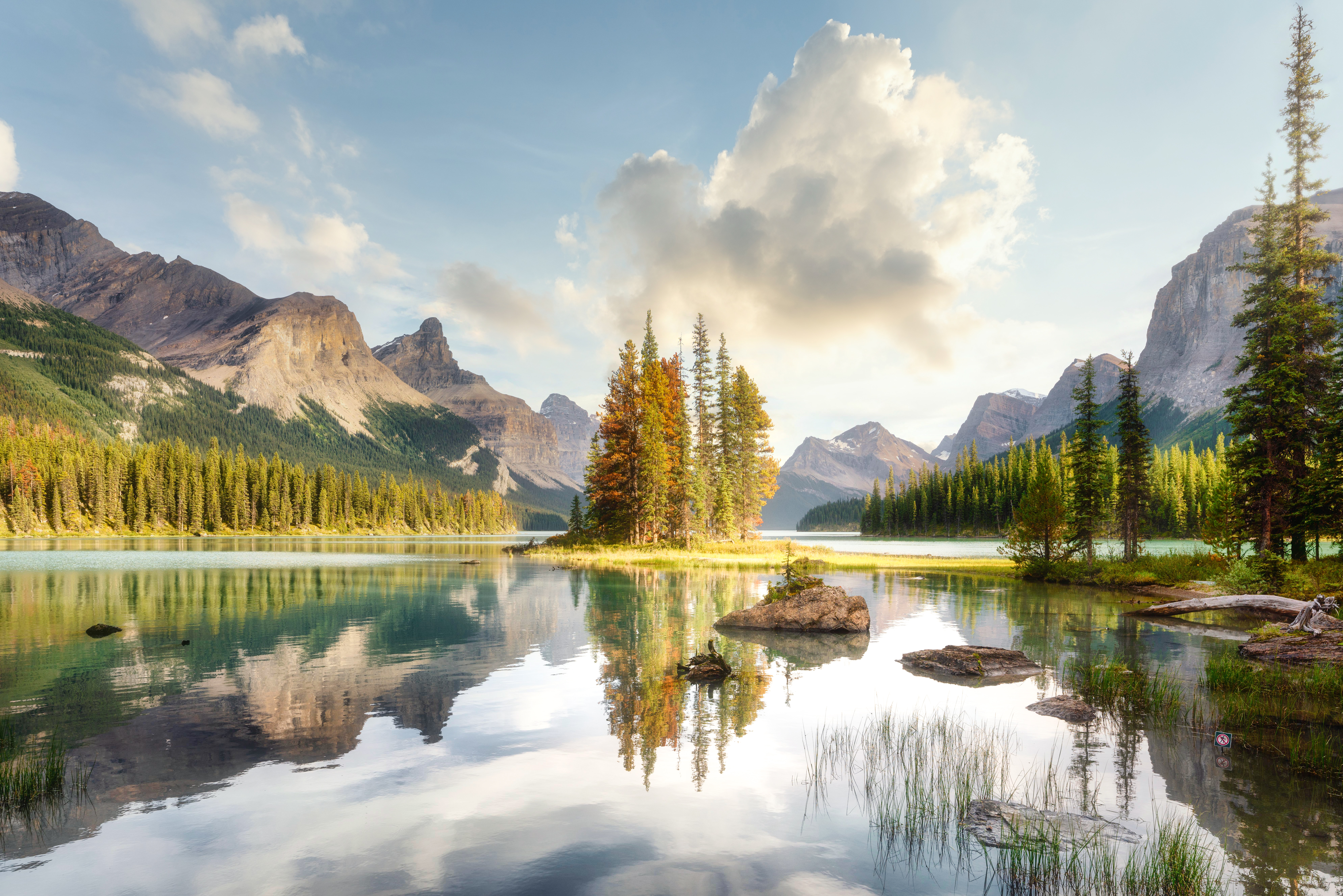 Blue skies over a glassy Maligne Lake in the Canadian Rockies