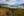 View of Bove Island on the Windy Arm of Tagish Lake, mountains and fall foliage with clouds above