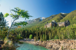 The Fairmont Banff Springs Hotel sits above a river, with trees and mountains behind