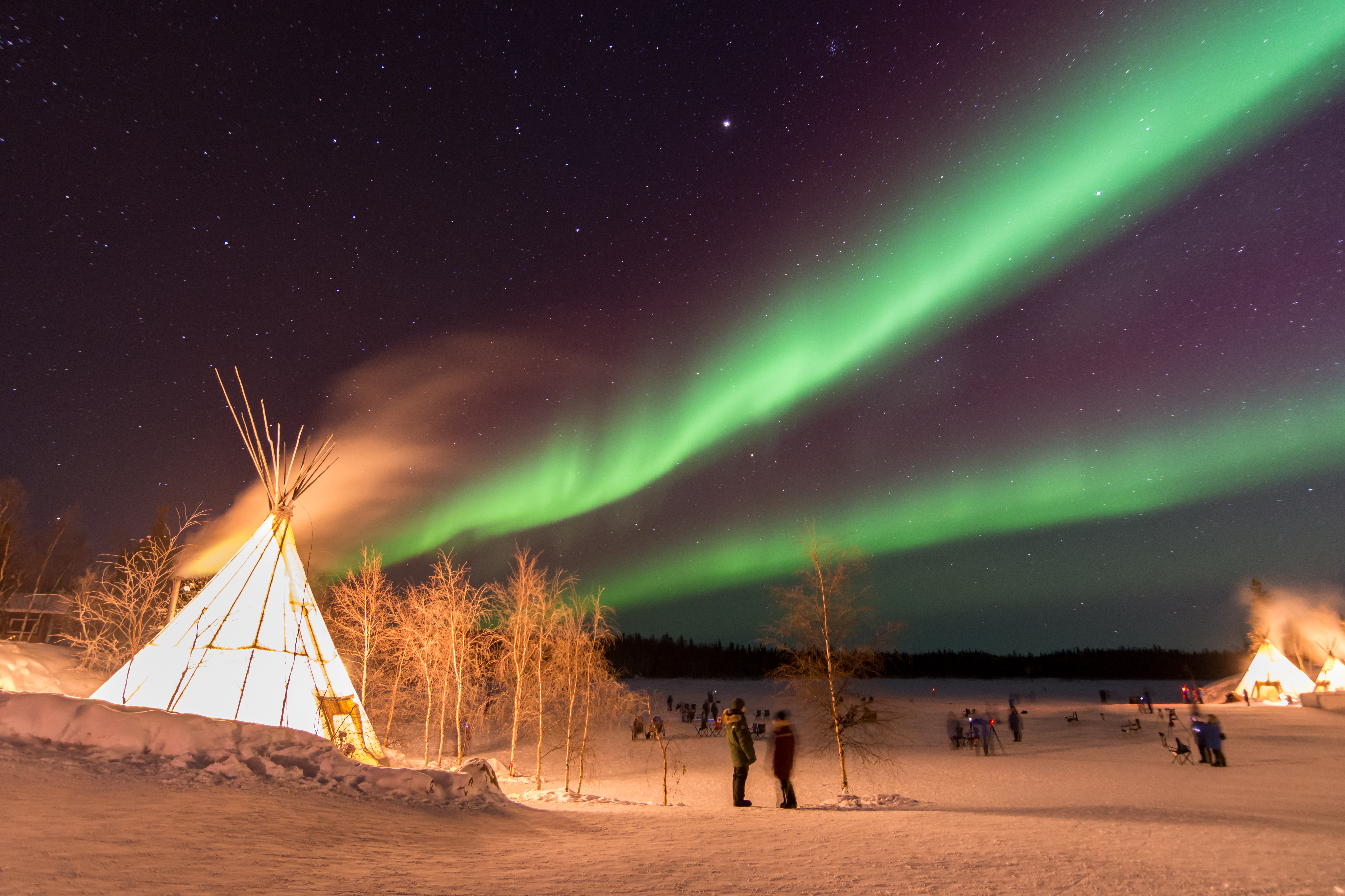 Northern Lights over teepees in the Aurora Village, Yellowknife