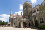 People walking near the entrance of Casa Loma, a castle-style mansion in Toronto