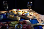 Charcuterie boards and alcoholic drinks on wooden table