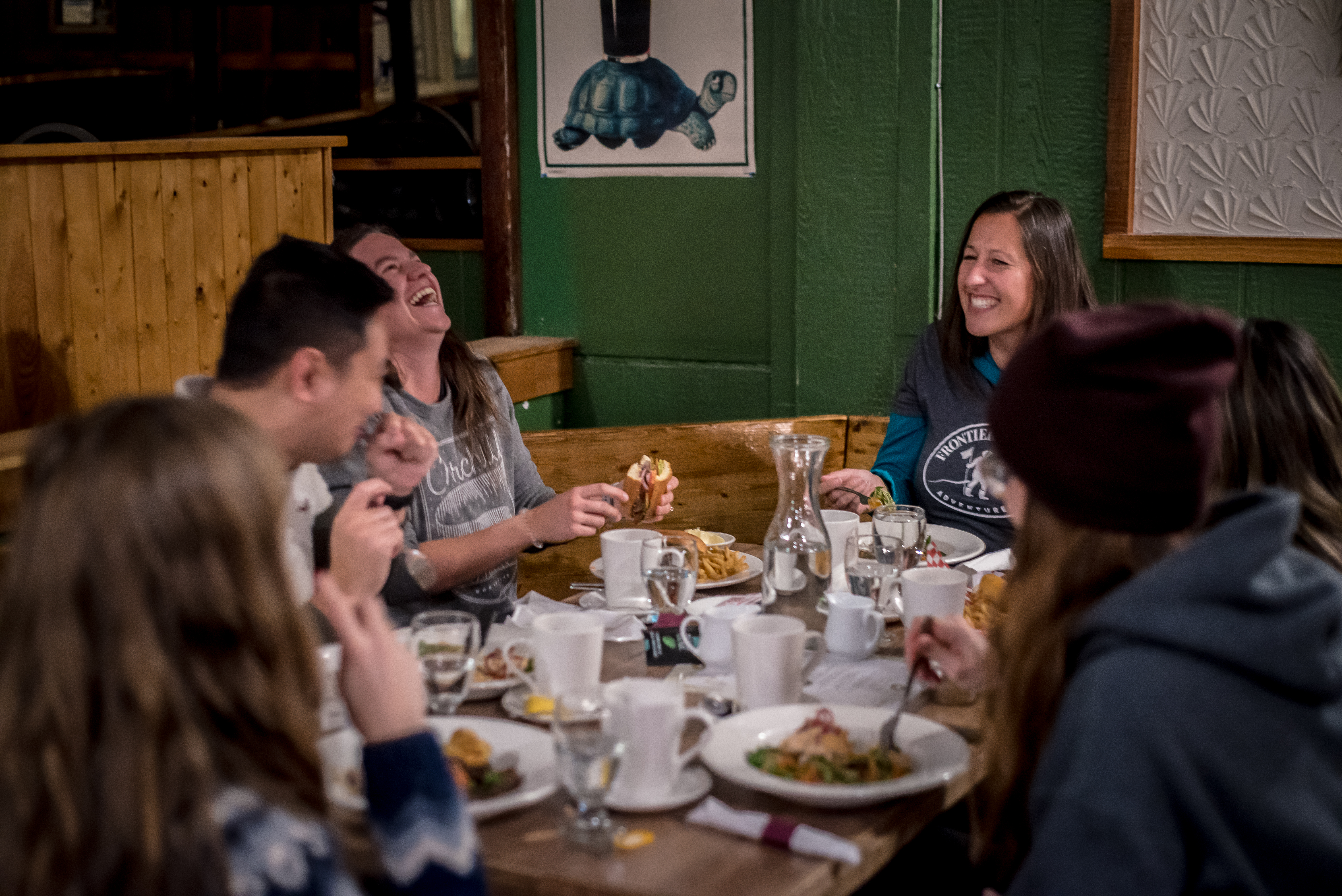 Group of travellers enjoy meal at local favourite spot, Tundra Pub and Dining Room located in the heart of Manitoba's Churchill 