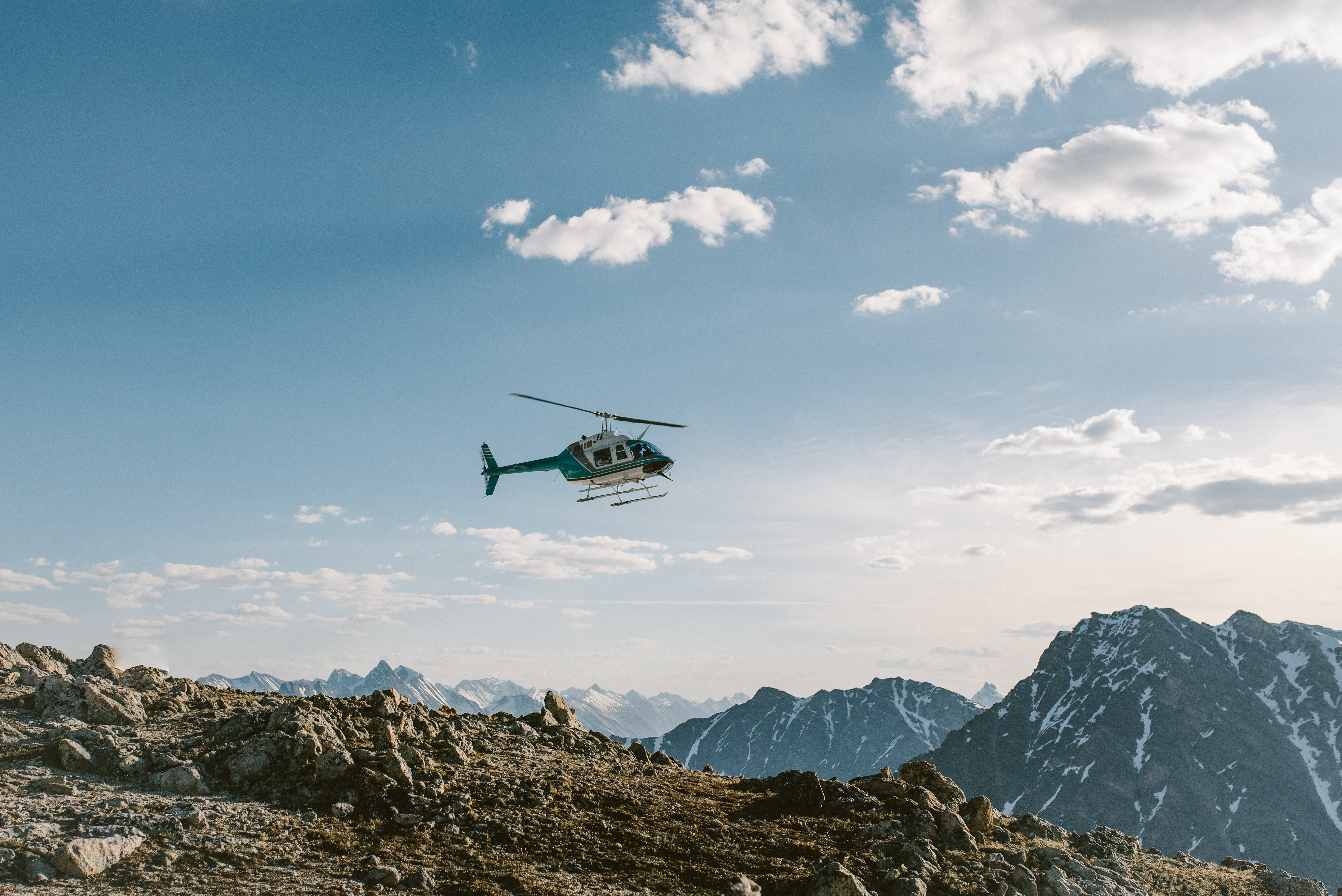 A helicopter flys over the mountains in Jasper National Park 