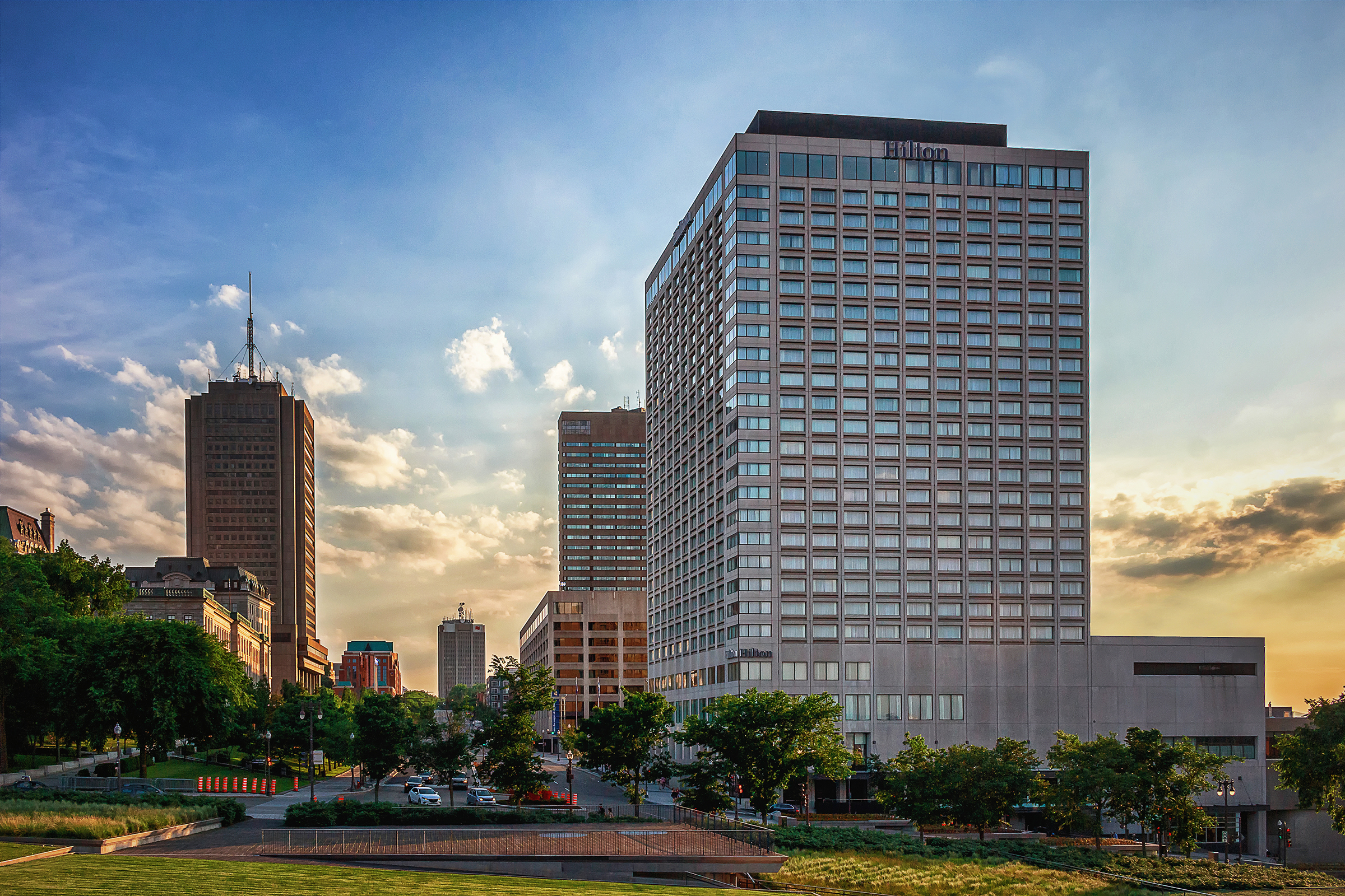 Hilton Quebec, tall buildings and green trees against a blue sky in Quebec City
