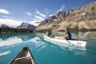 Two kayaks in Lake Louise with Rockies in the background