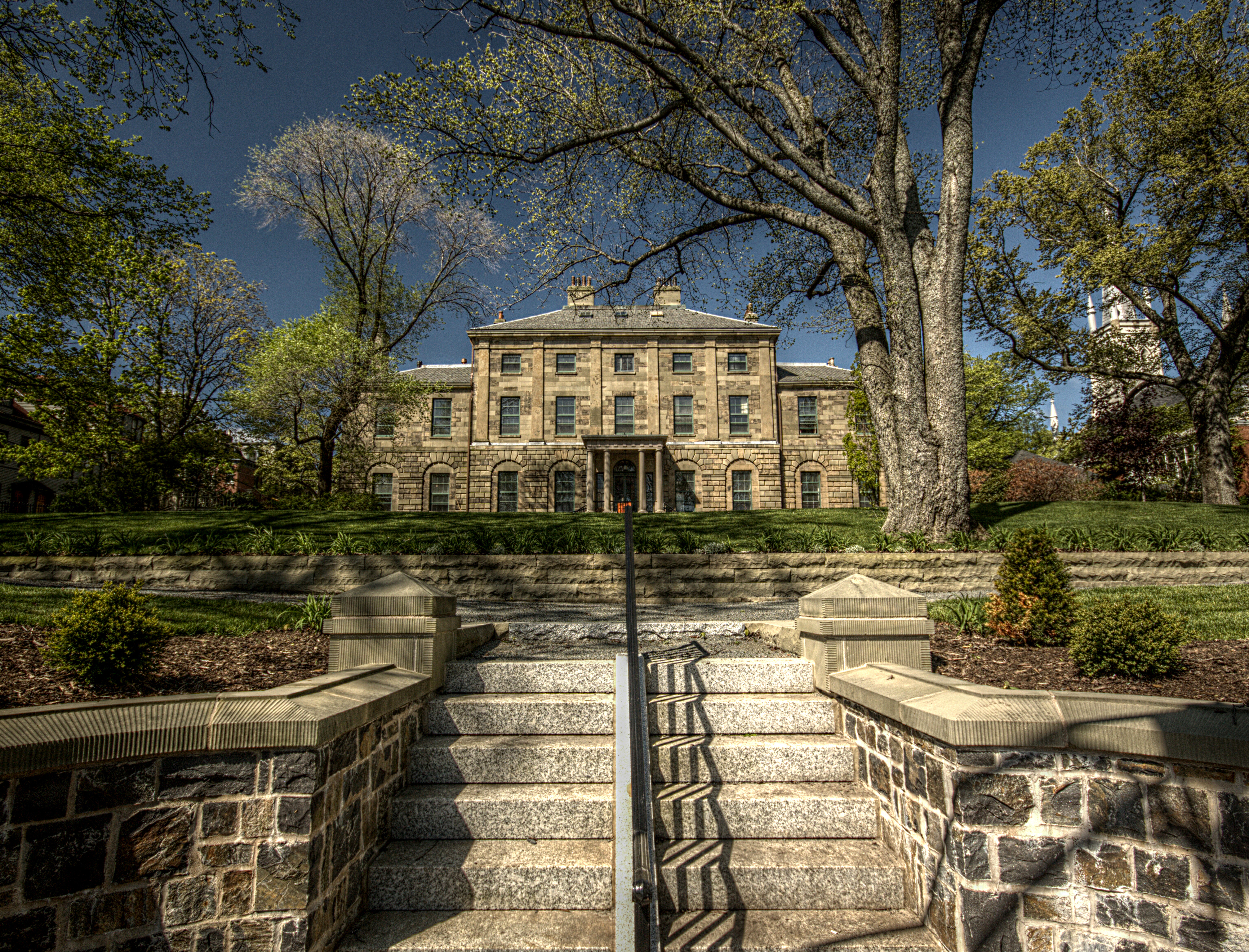 Steps leading up to the gardens outside a large historic mansion, Government House in Halifax