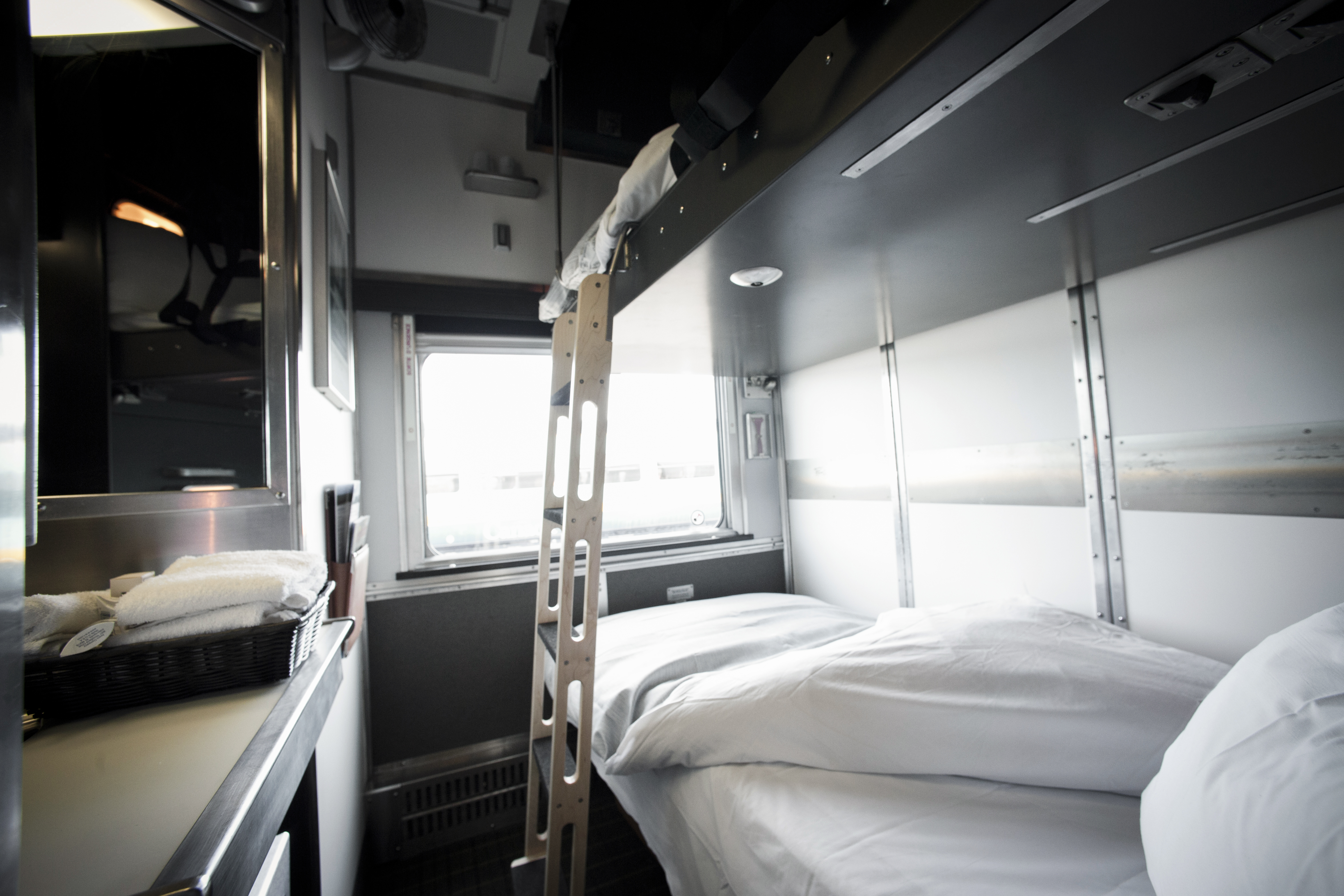 A cabin for two in VIA Rail’s Sleeper Plus contains daytime seating that converts into bunk beds (shown here) at night.