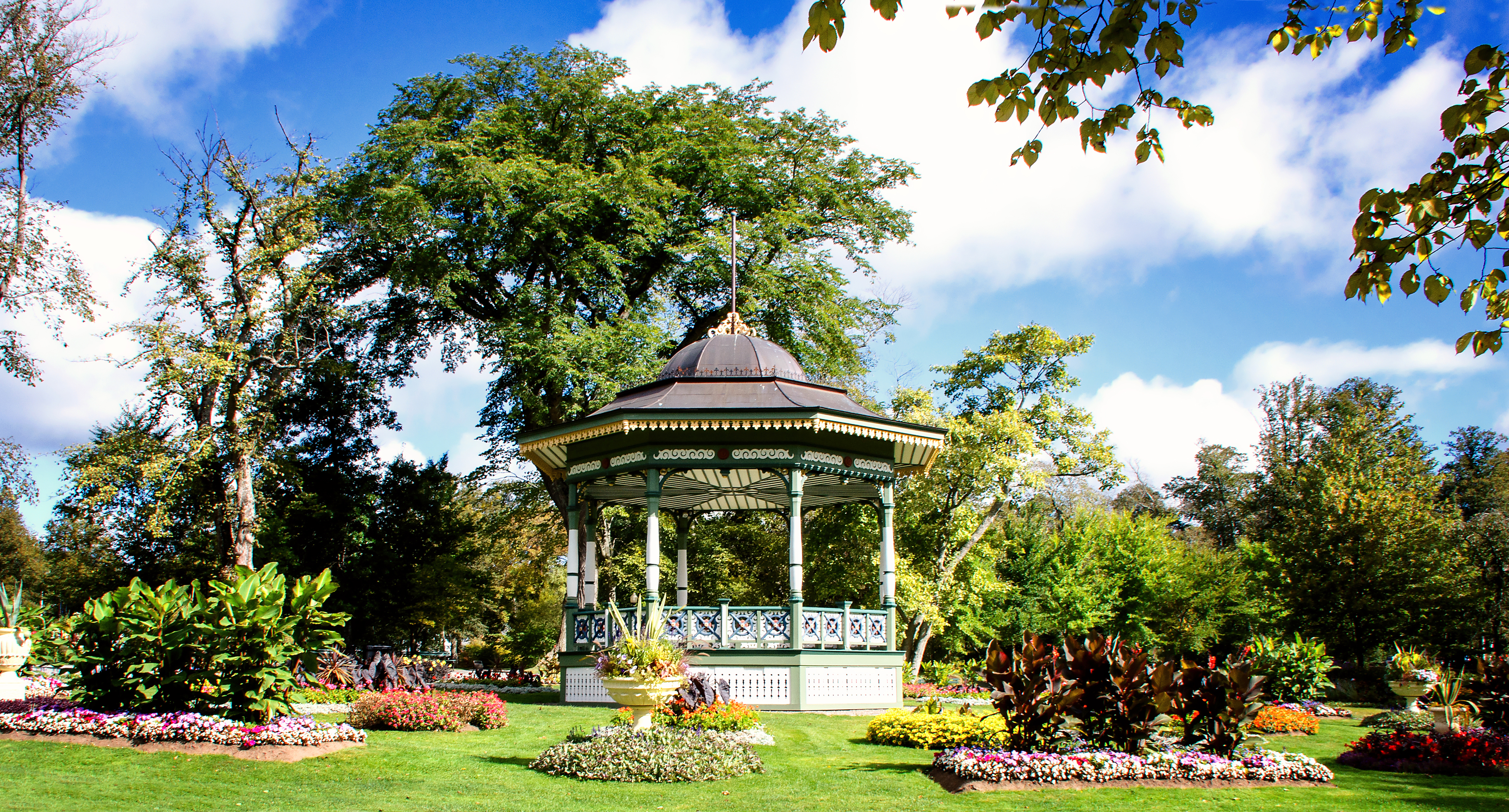 Picturesque Victorian garden with floral displays and decorative bandstand