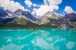 Two canoes on the turquoise blue water of Maligne Lake in Jasper National park