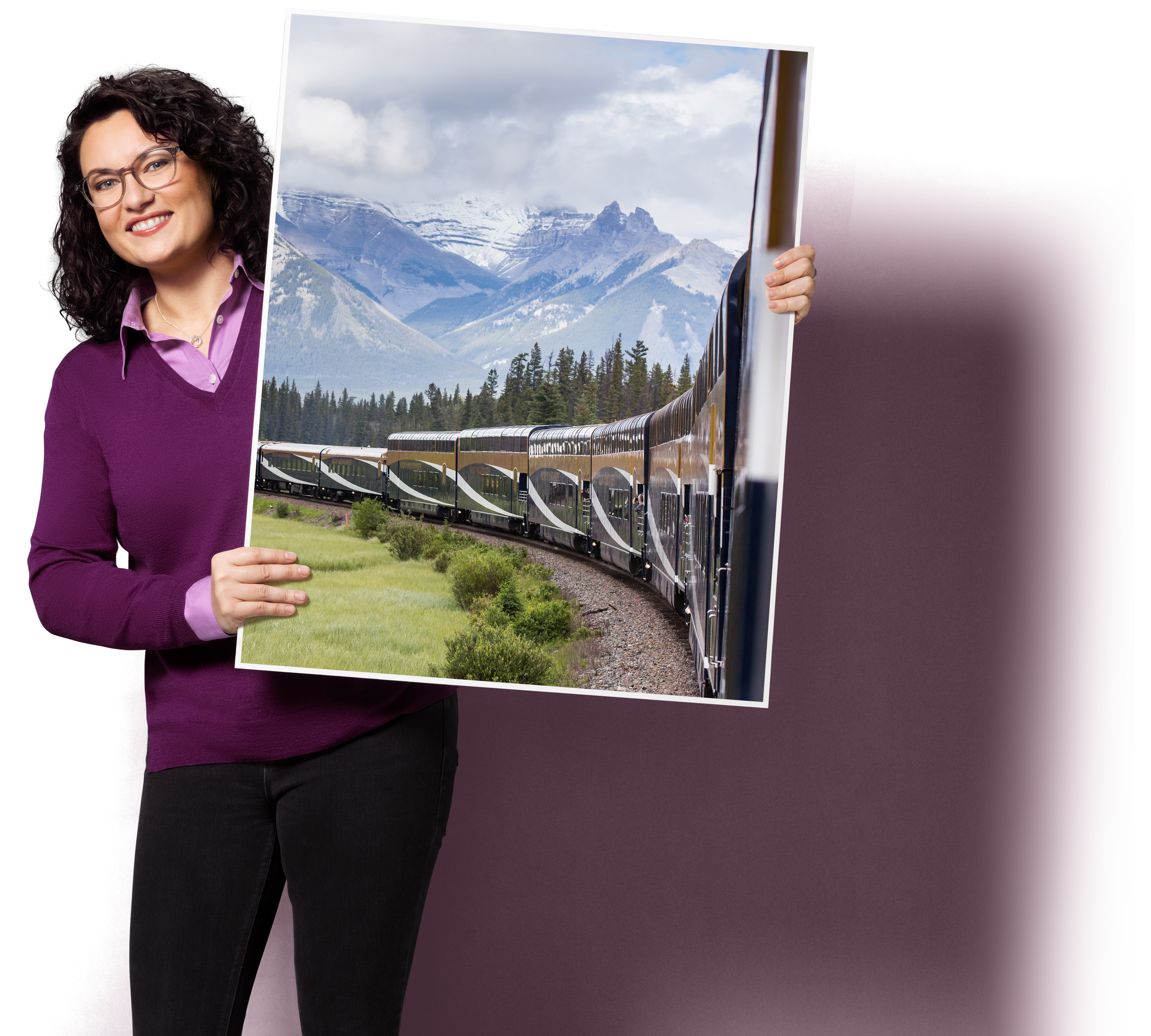A person holding a large sign board with Canadian scenery on it
