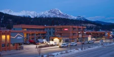 The Crimson Hotel in winter with snowy mountains behind