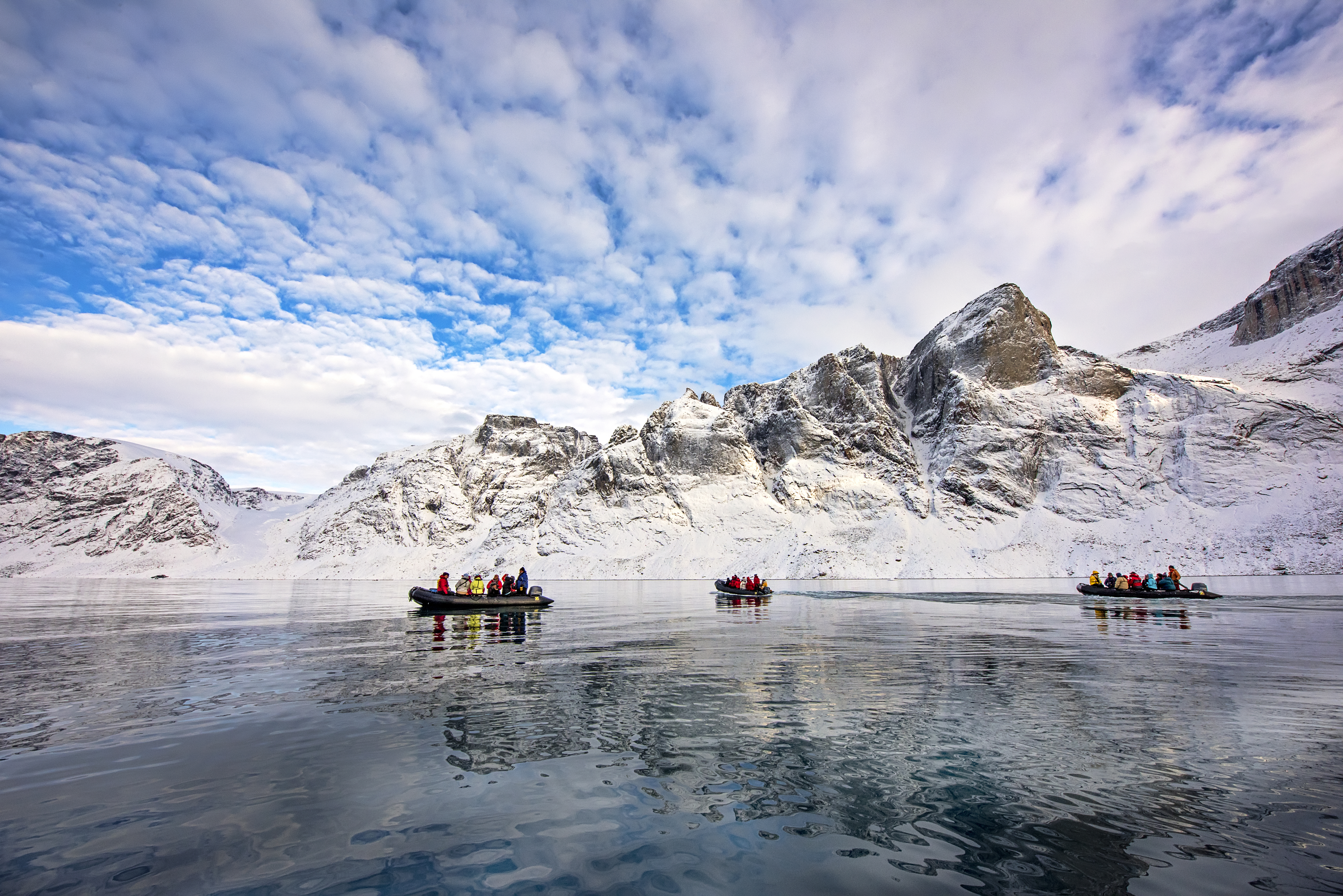 Three boats with people in the Buchan Gulf