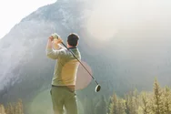 A man golfing at the Fairmont Banff Spring in the Rockies