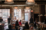 People sitting in a brick-walled coffee shop