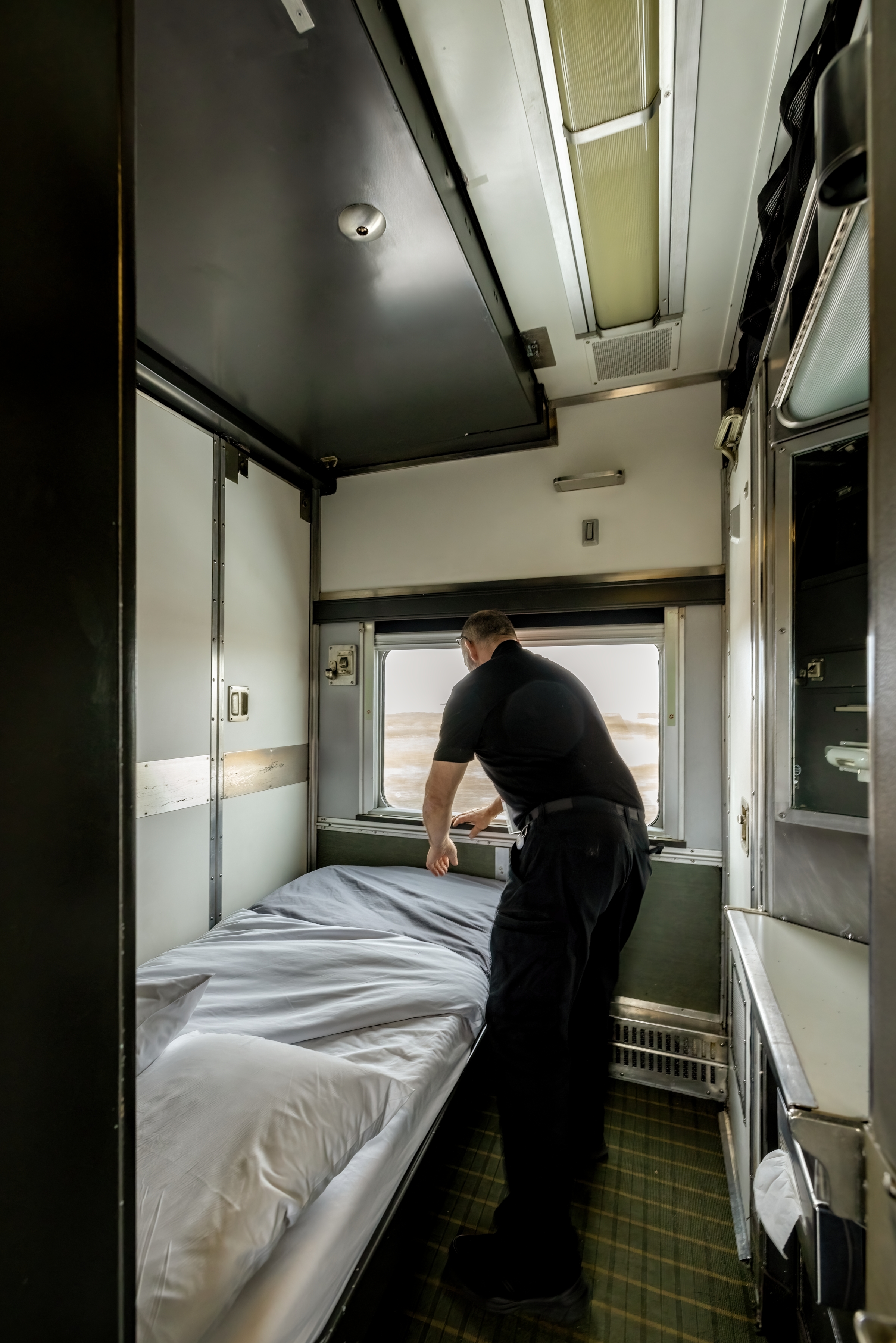 A VIA Rail attendant on The Canada train converts the Cabin for Two from day set-up to night set-up.