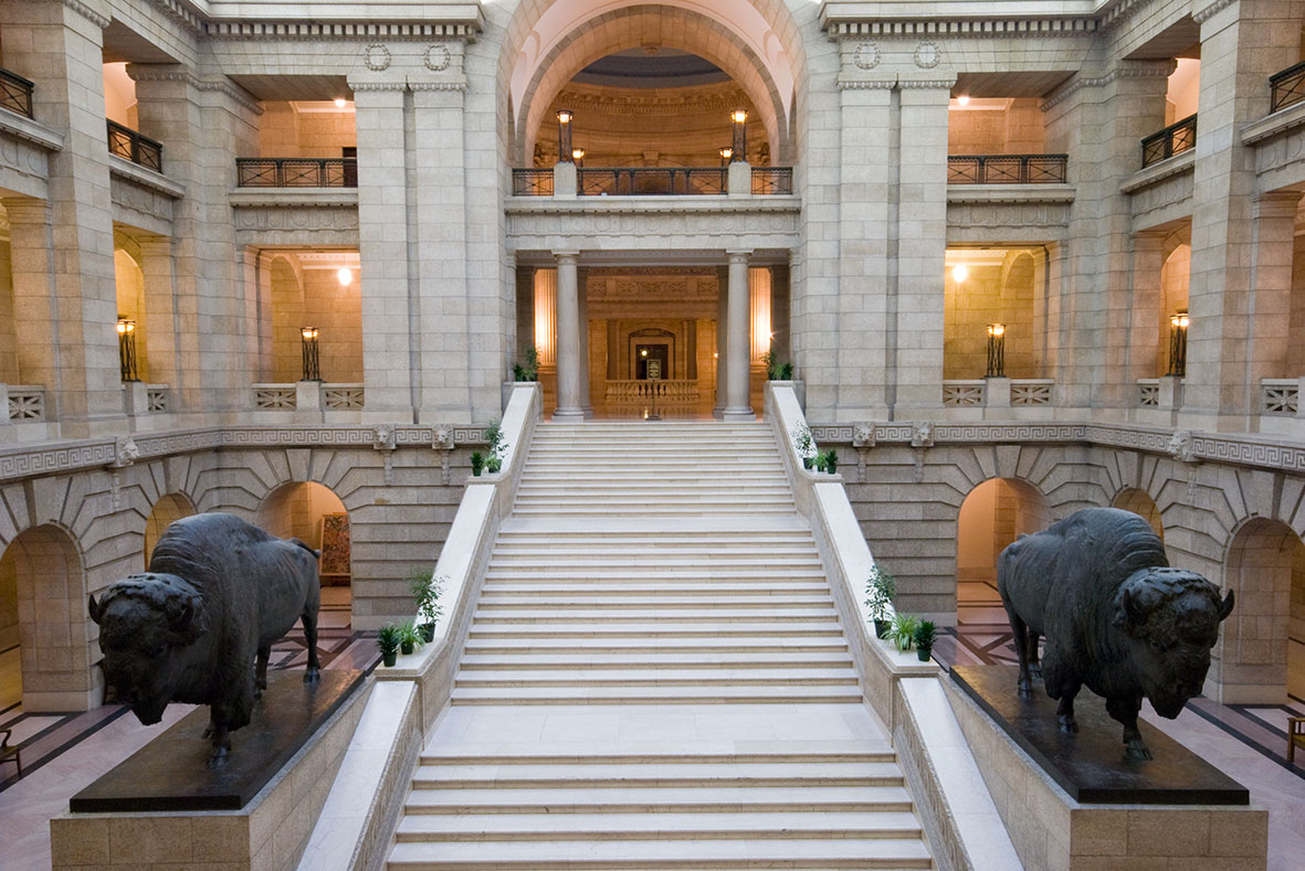 Grand staircase and two bison sculptures inside the Manitoba Legislative Building