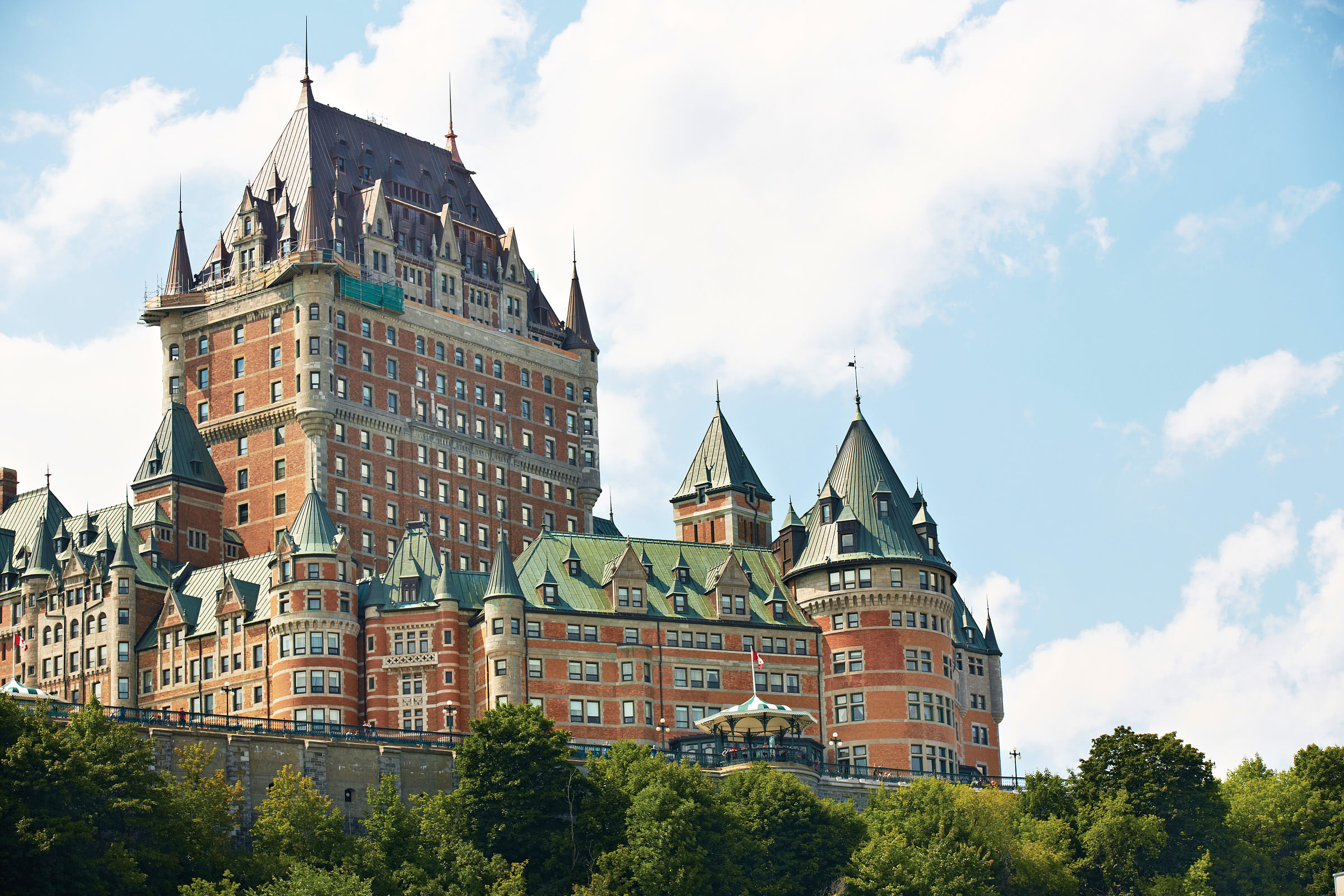Exterior of Fairmont Le Château Frontenac, a castle-like hotel under a blue sky