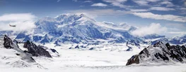 A small airplane flies over Kluane National Park