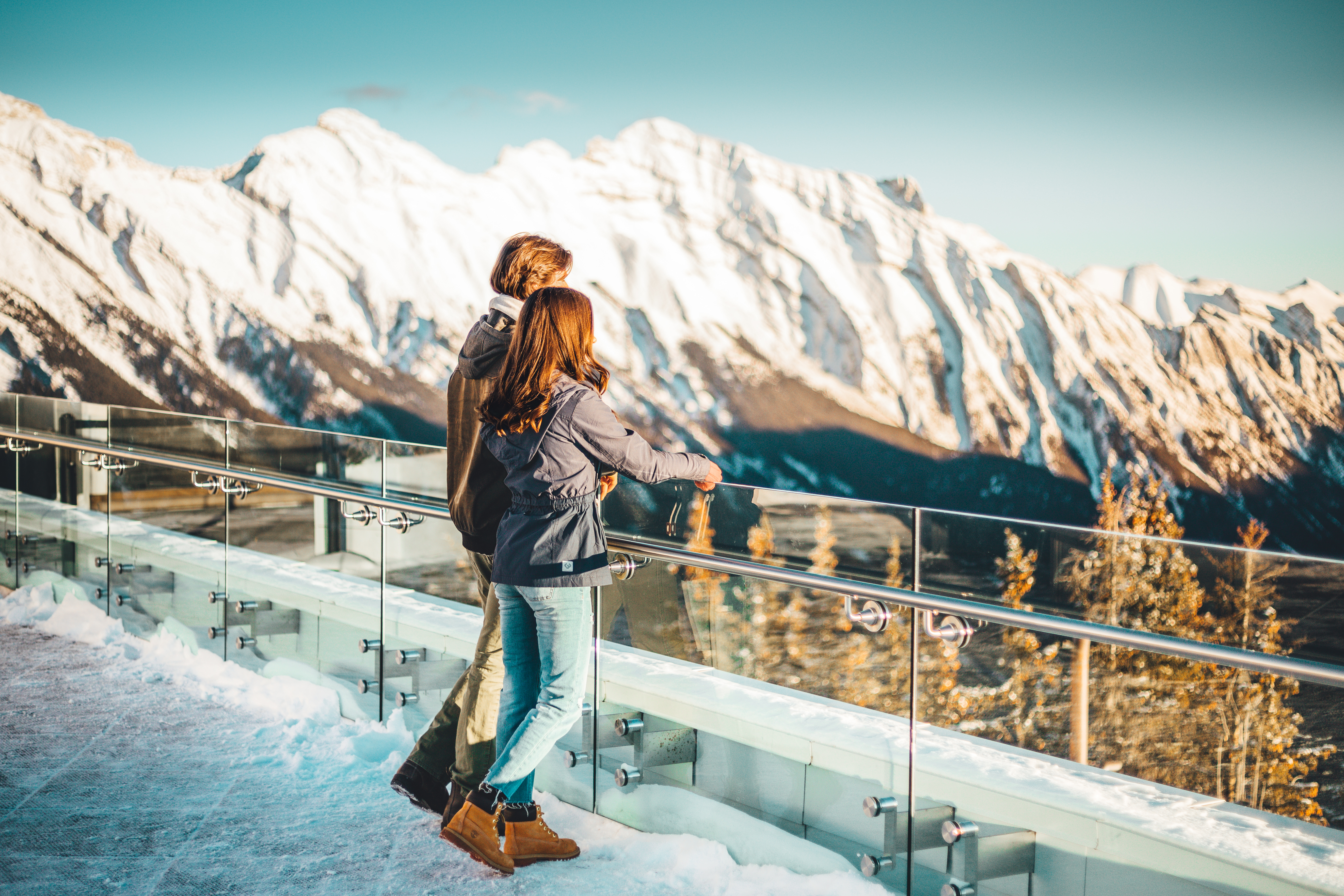 A couple takes in the view from a platform at the top of Banff Gondola.