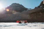 Group of people get off the Ice Explorer and walk onto the Columbia Icefield glacier
